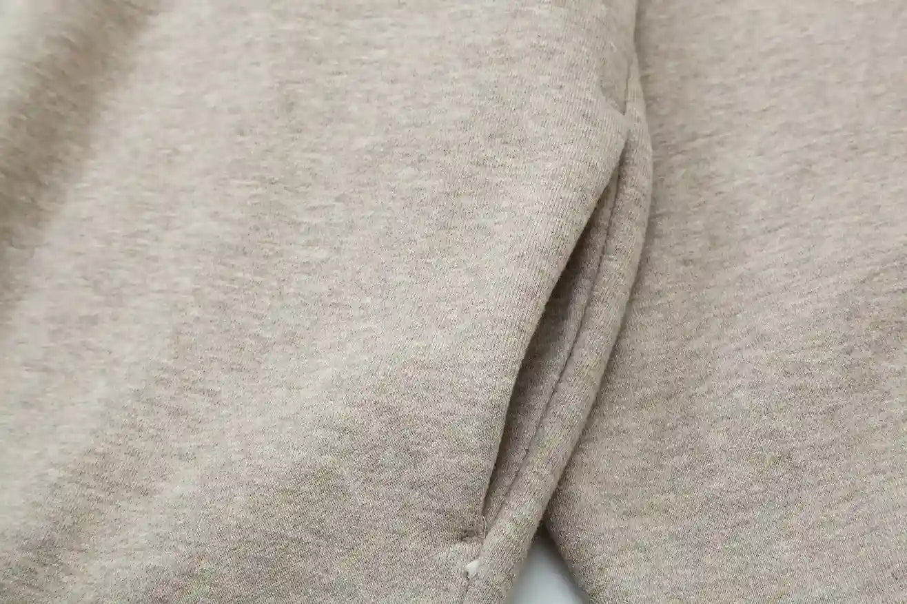 Fear of God Essentials heathered grey hoodie front view with rubberized black bar branding