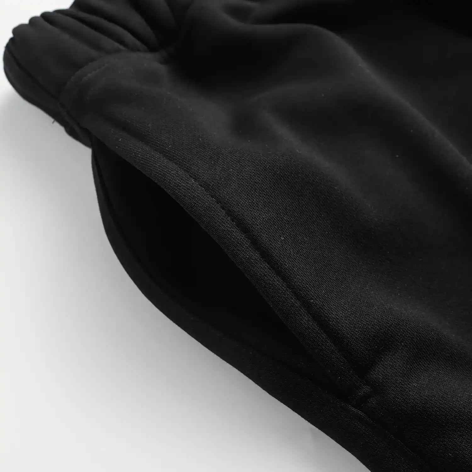 Fear of God Essentials black fleece shorts with tonal logo and oversized fit