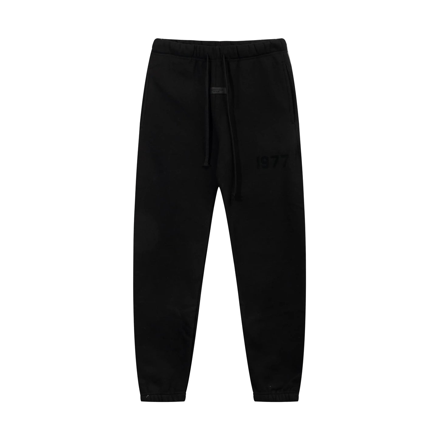 Black Essentials joggers soft-touch rubberized logo on leg close-up