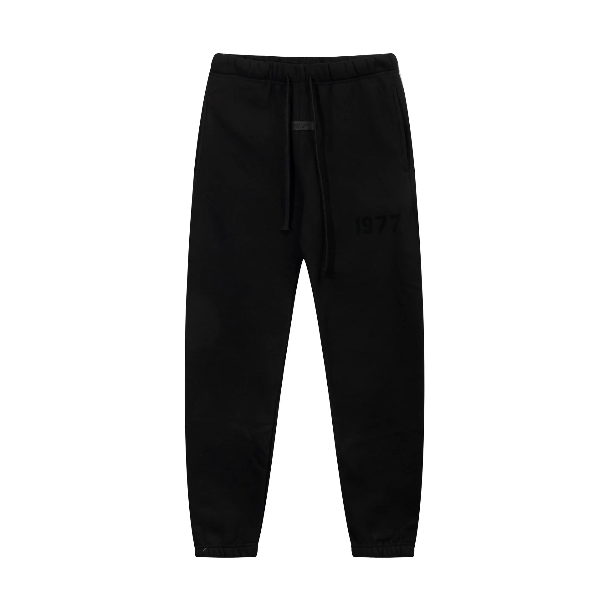 Black Essentials joggers soft-touch rubberized logo on leg close-up
