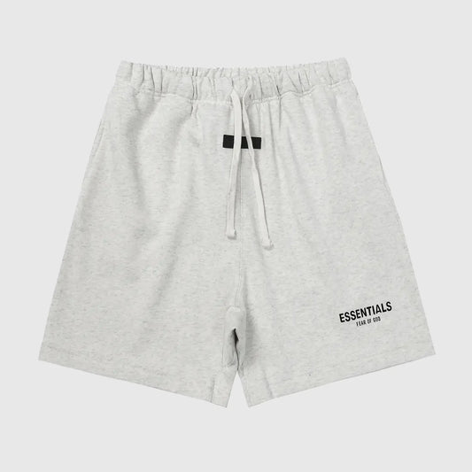 Fear of God Essentials light heather oatmeal fleece shorts with tonal branding and relaxed silhouette