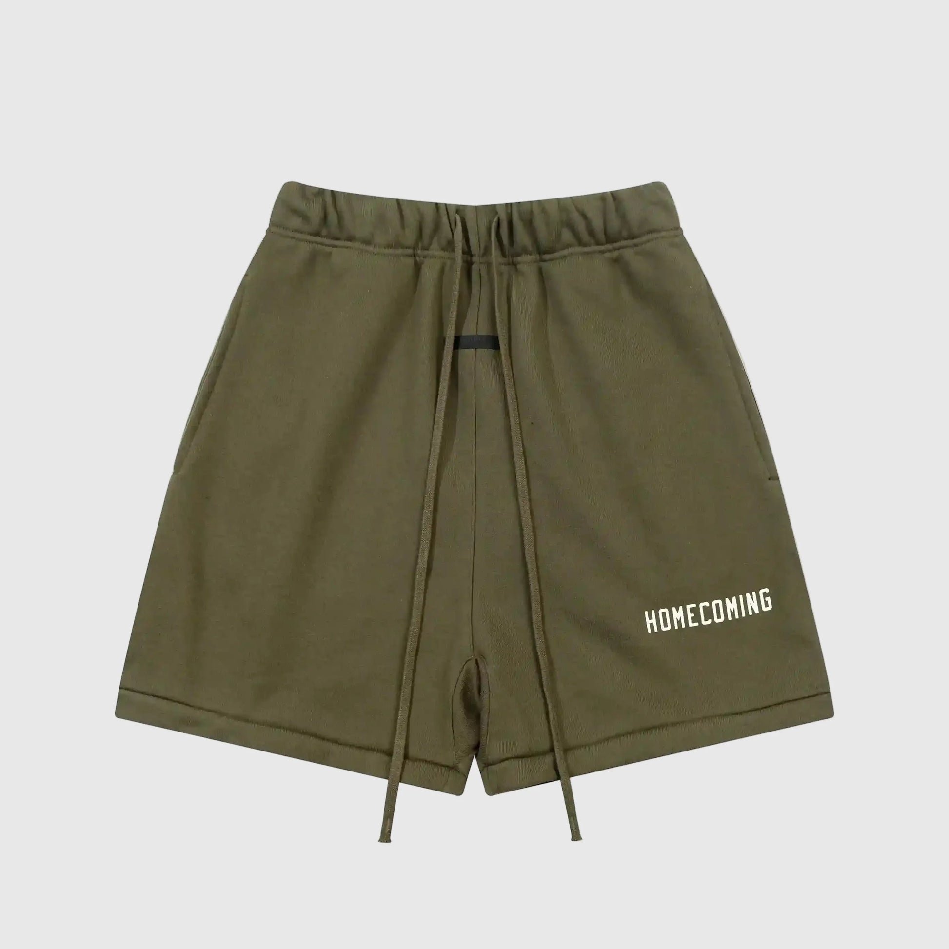 Front view of green Fear of God Essentials Hemlock shorts with elastic waistband