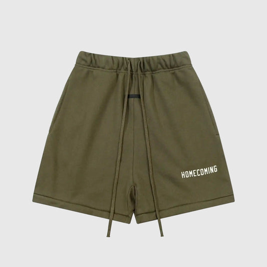 Front view of green Fear of God Essentials Hemlock shorts with elastic waistband