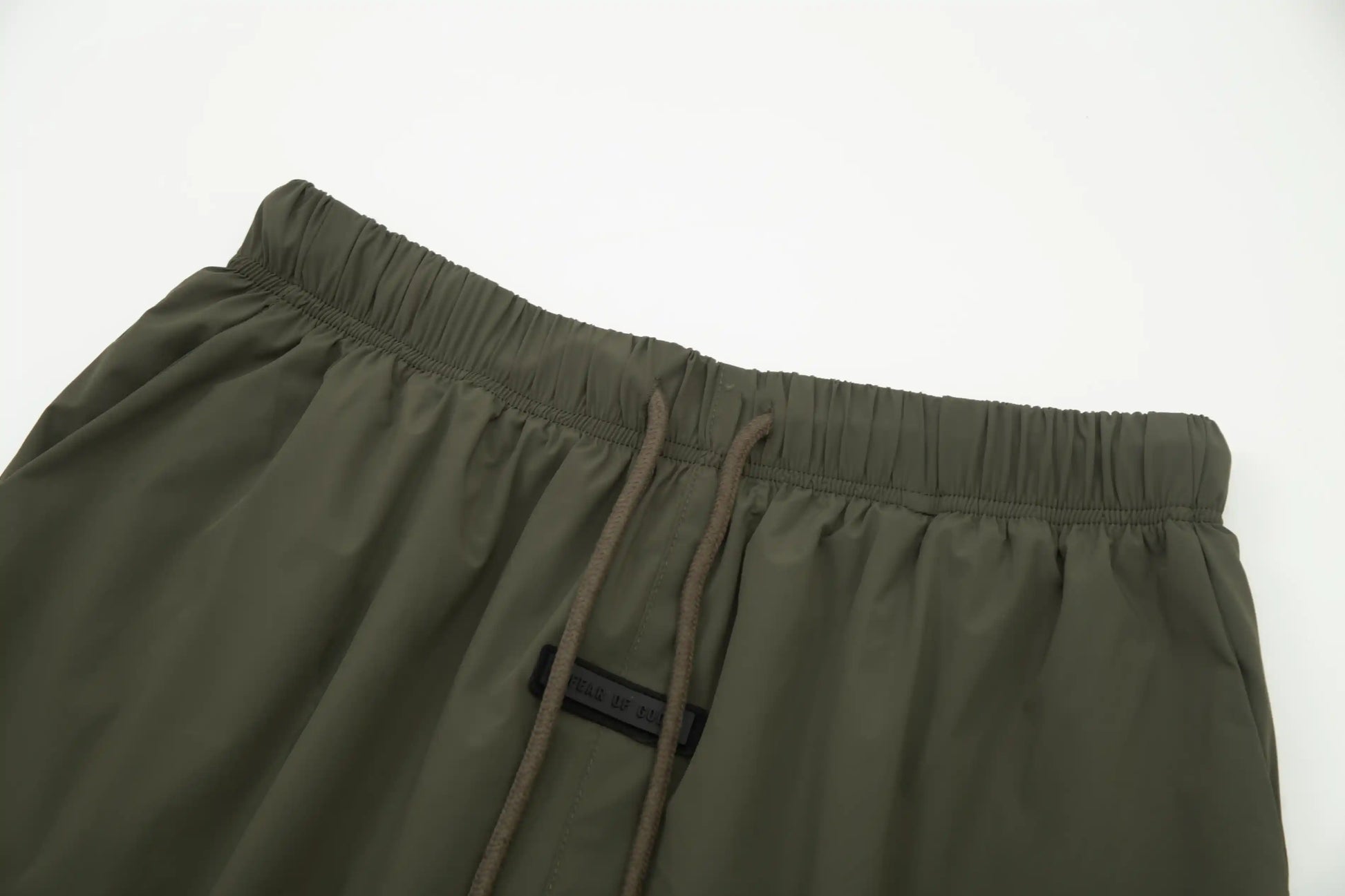 Fear of God Essentials hemlock green fleece shorts with tonal logo and relaxed fit