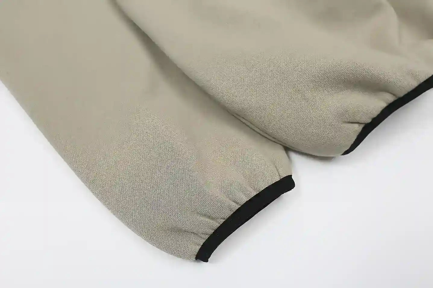 Fear of God Essentials cement hoodie front view with rubberized black bar branding