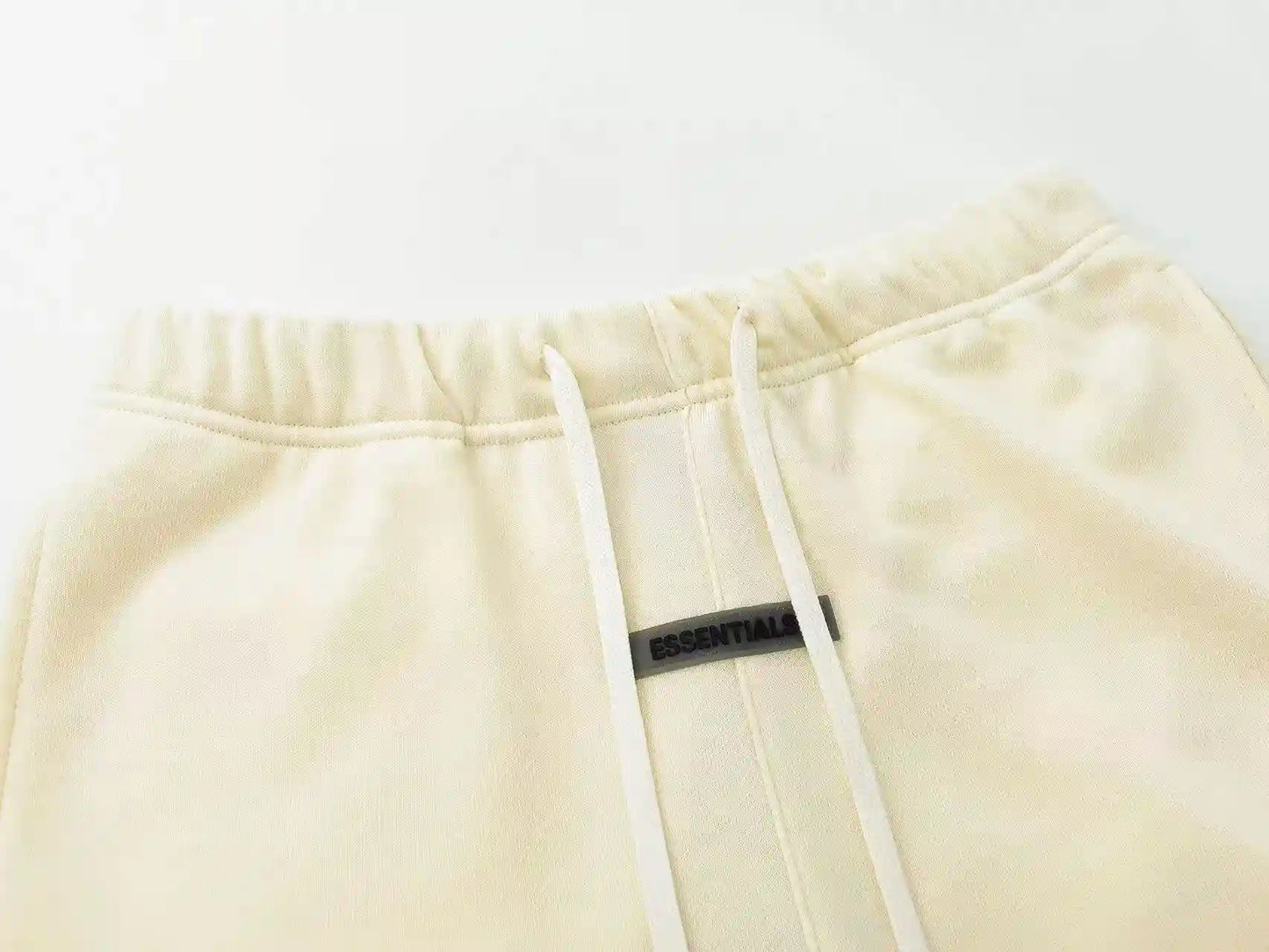 Fear of God Essentials Cloud Dance fleece shorts in off-white with tonal branding and relaxed fit