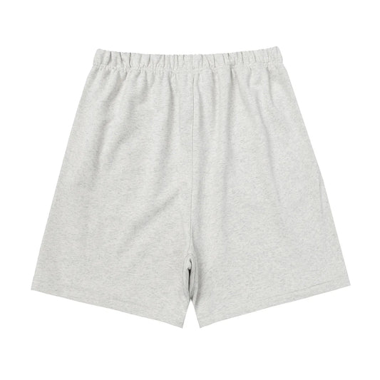 Fear of God Essentials light heather oatmeal fleece shorts with tonal branding and relaxed silhouette