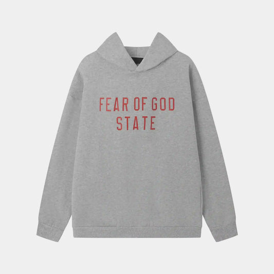 Fear of God Essentials light grey hoodie front view with rubberized Black Bar branding
