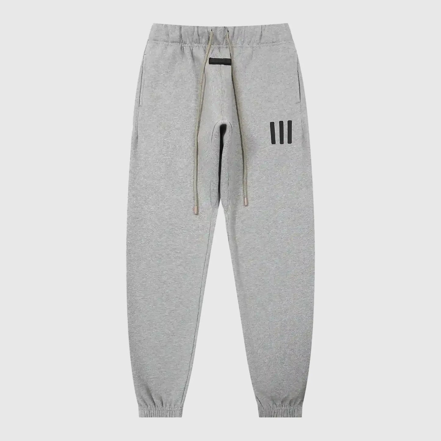 Jogger style dark heather oatmeal sweatpants by Fear of God with elastic waistband