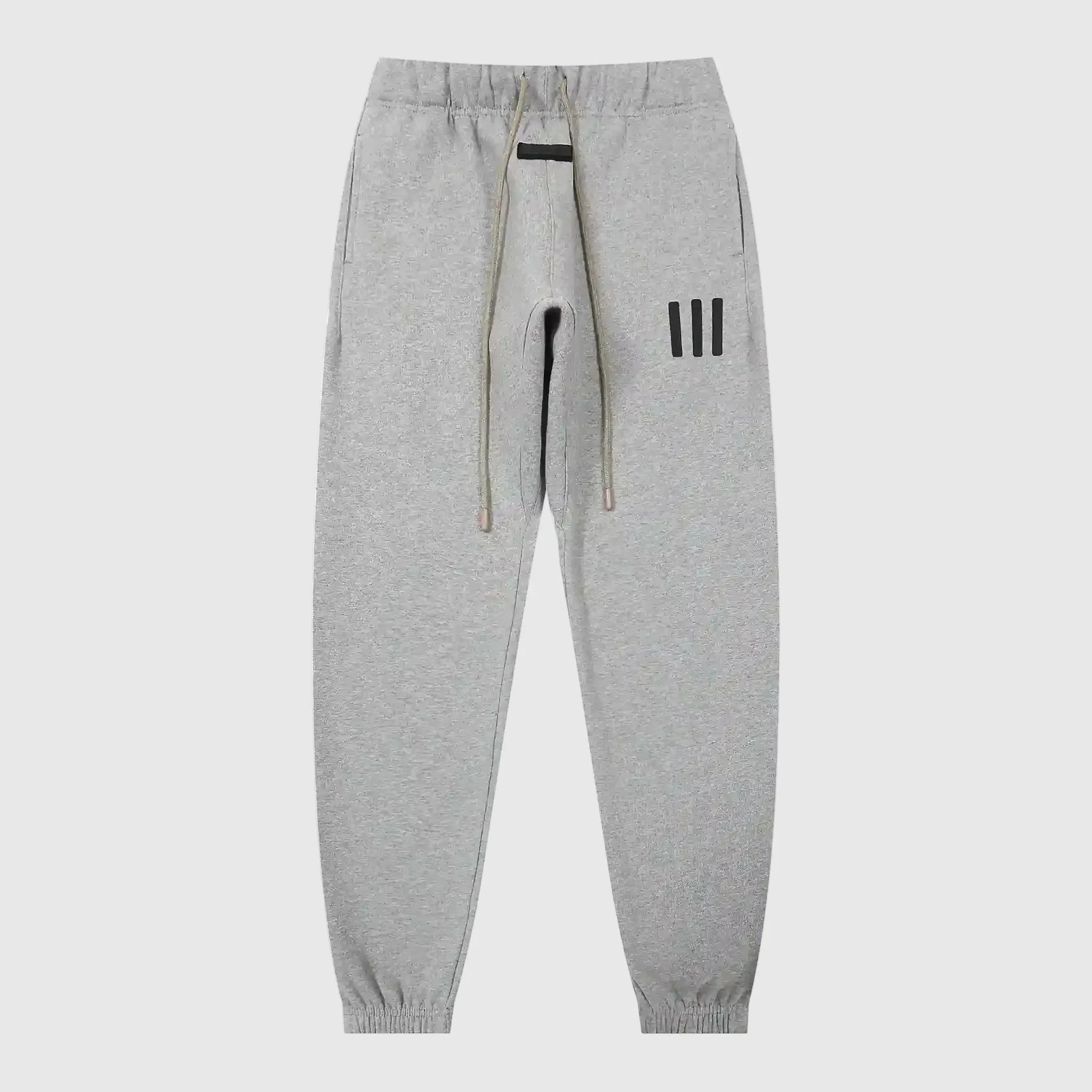 Jogger style dark heather oatmeal sweatpants by Fear of God with elastic waistband