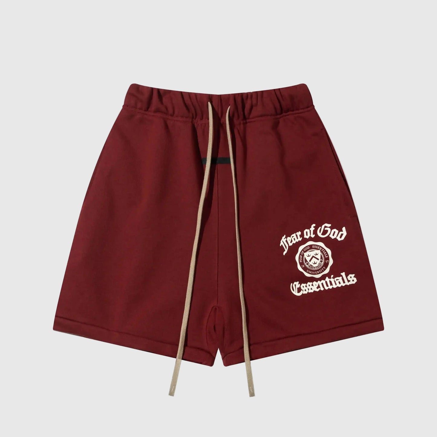 Fear of God Essentials red fleece shorts with tonal branding and relaxed silhouette