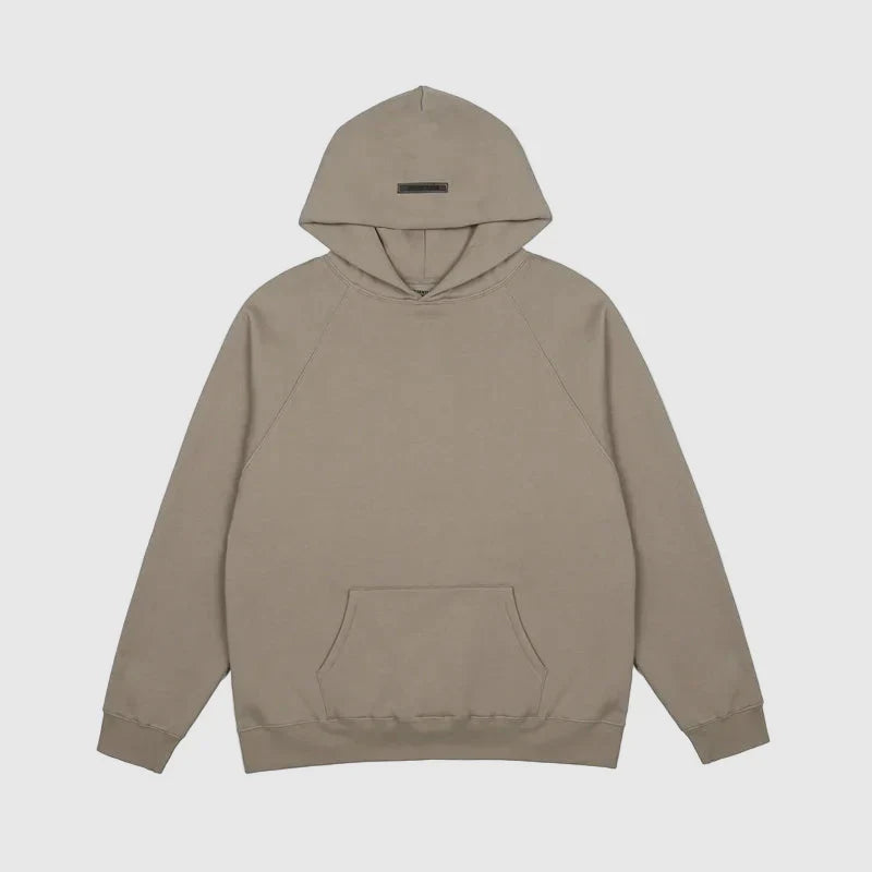 Fear of God Essentials sandrift hoodie front view with rubberized Black Bar branding