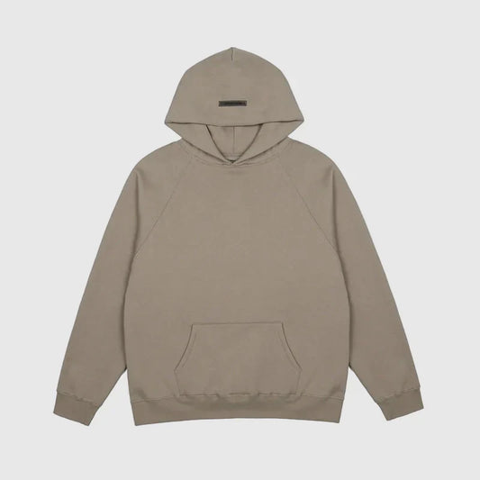 Fear of God Essentials sandrift hoodie front view with rubberized Black Bar branding