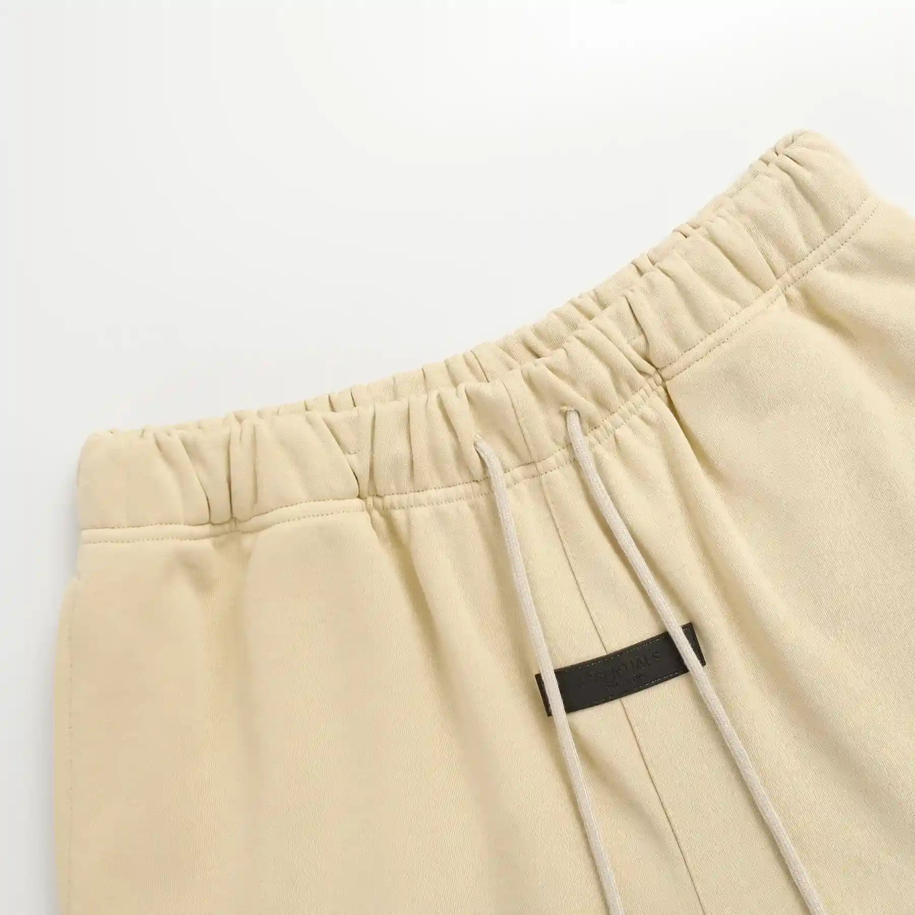 Fear of God Essentials Calm Shell Shorts in beige fleece with drawstring waistband