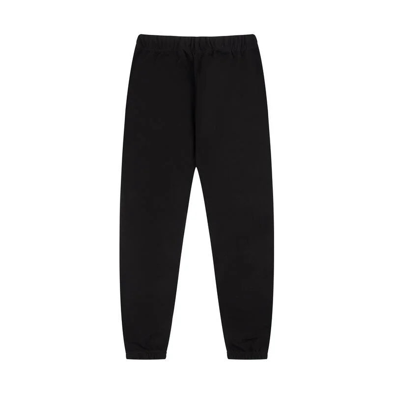 Essentials rubberized label detail on black tracksuit (hood or front label)