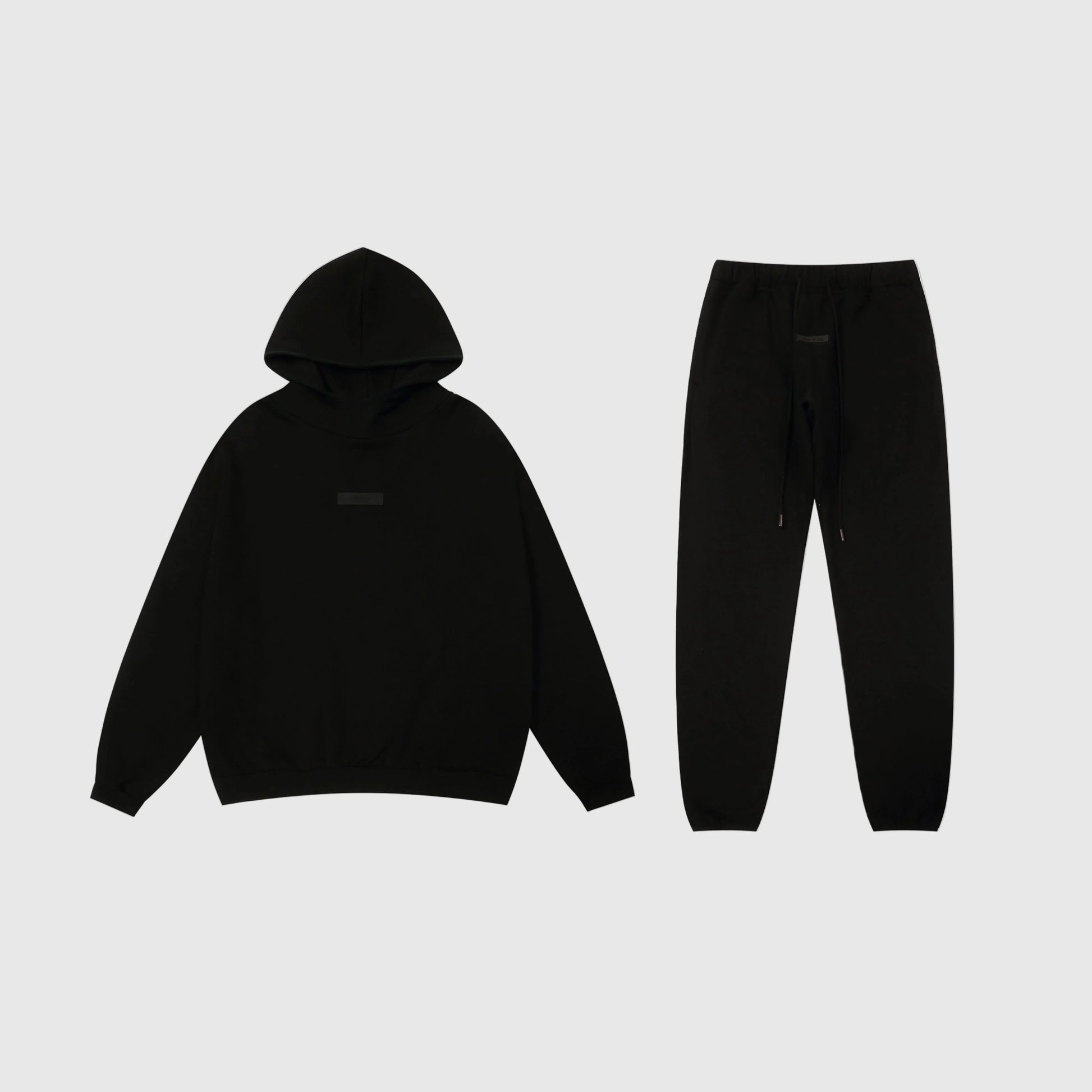 Fear of God Essentials black tracksuit set front view hoodie and joggers