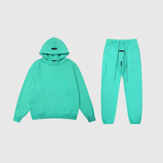 Fear of God Essentials aqua green tracksuit set front view hoodie and joggers