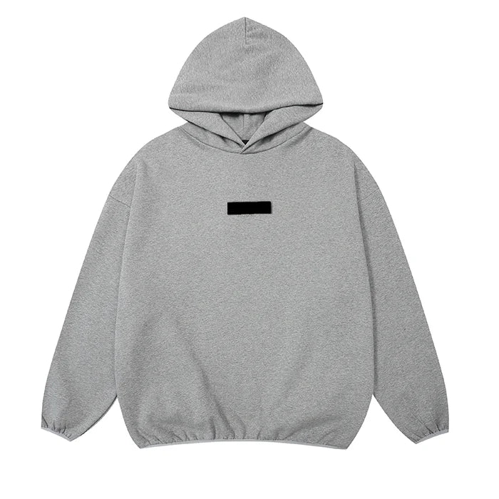 Dark heather oatmeal Essentials hoodie center front rubberized black bar branding detail