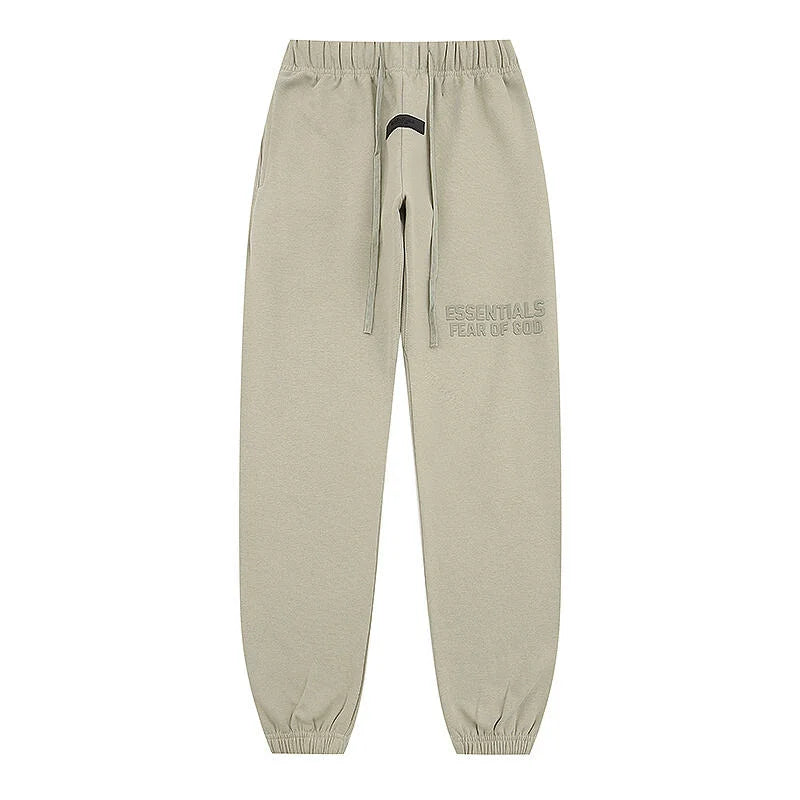 Heathered grey Essentials joggers soft-touch rubberized logo on leg close-up