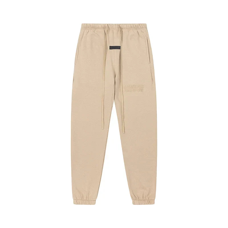Calm shell Essentials joggers soft-touch rubberized logo on leg close-up