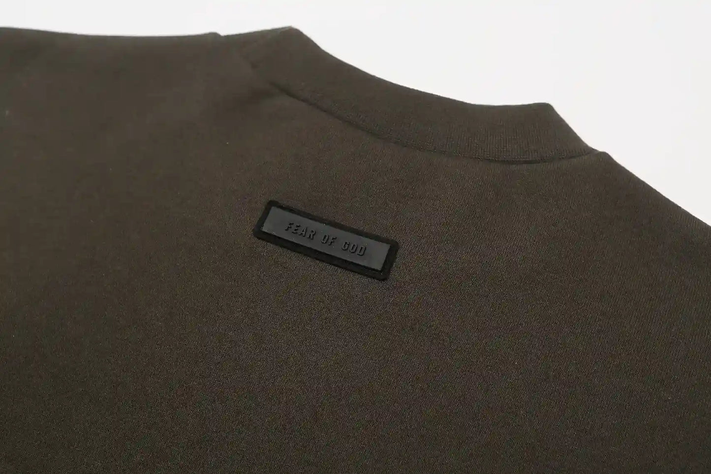English walnut Essentials joggers soft-touch rubberized logo on leg close-up
