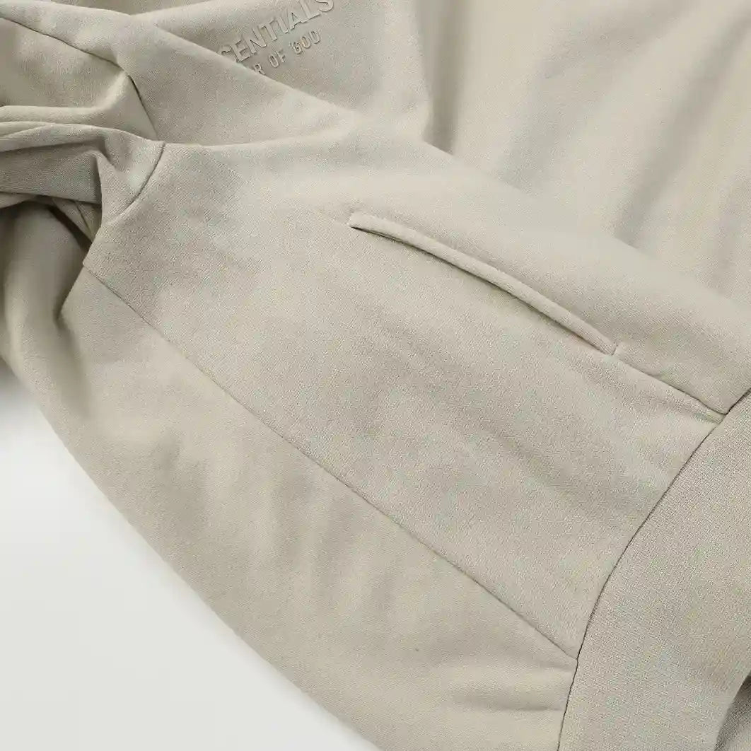 Heathered grey Essentials joggers soft-touch rubberized logo on leg close-up