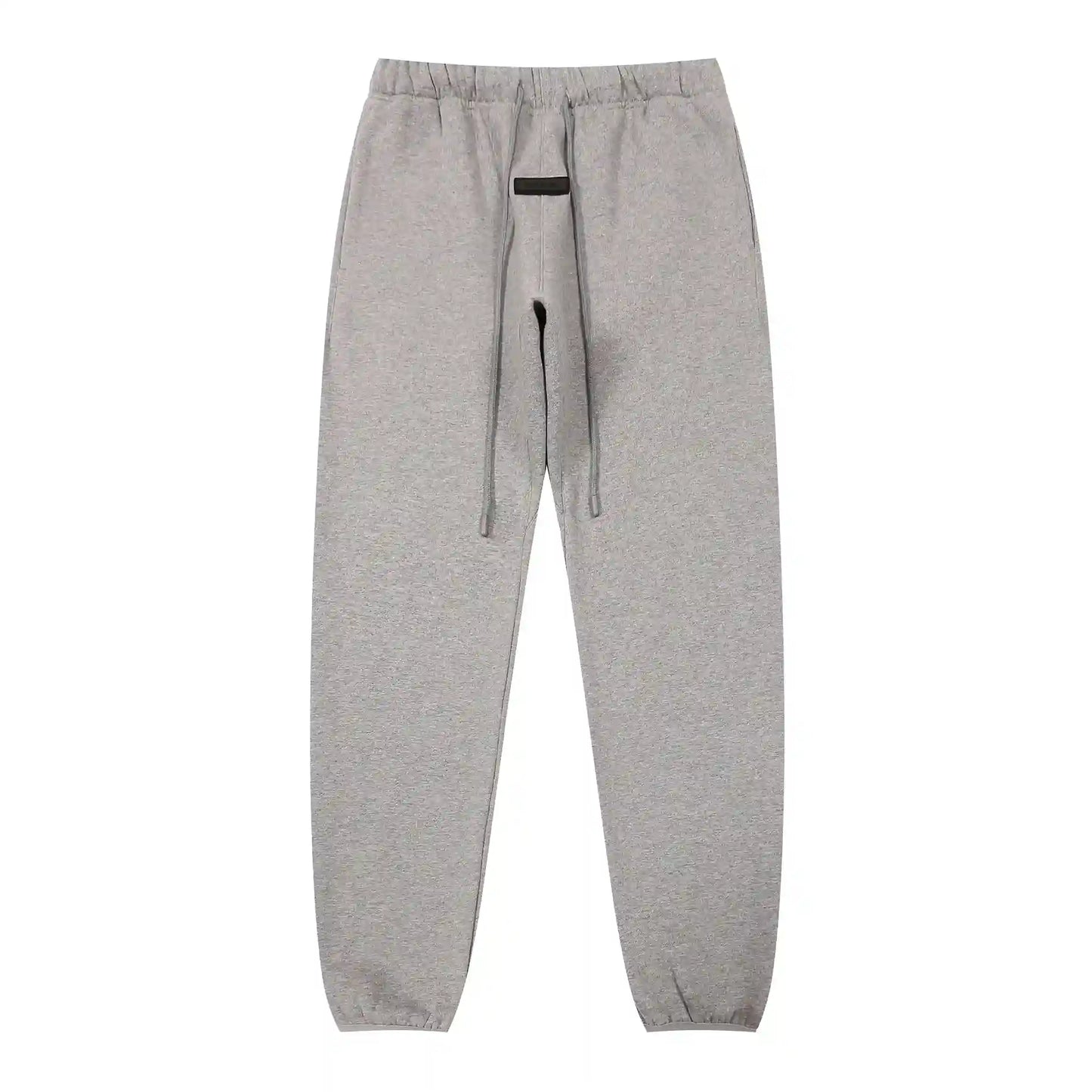 Dark heather oatmeal Essentials joggers soft-touch rubberized logo on leg close-up