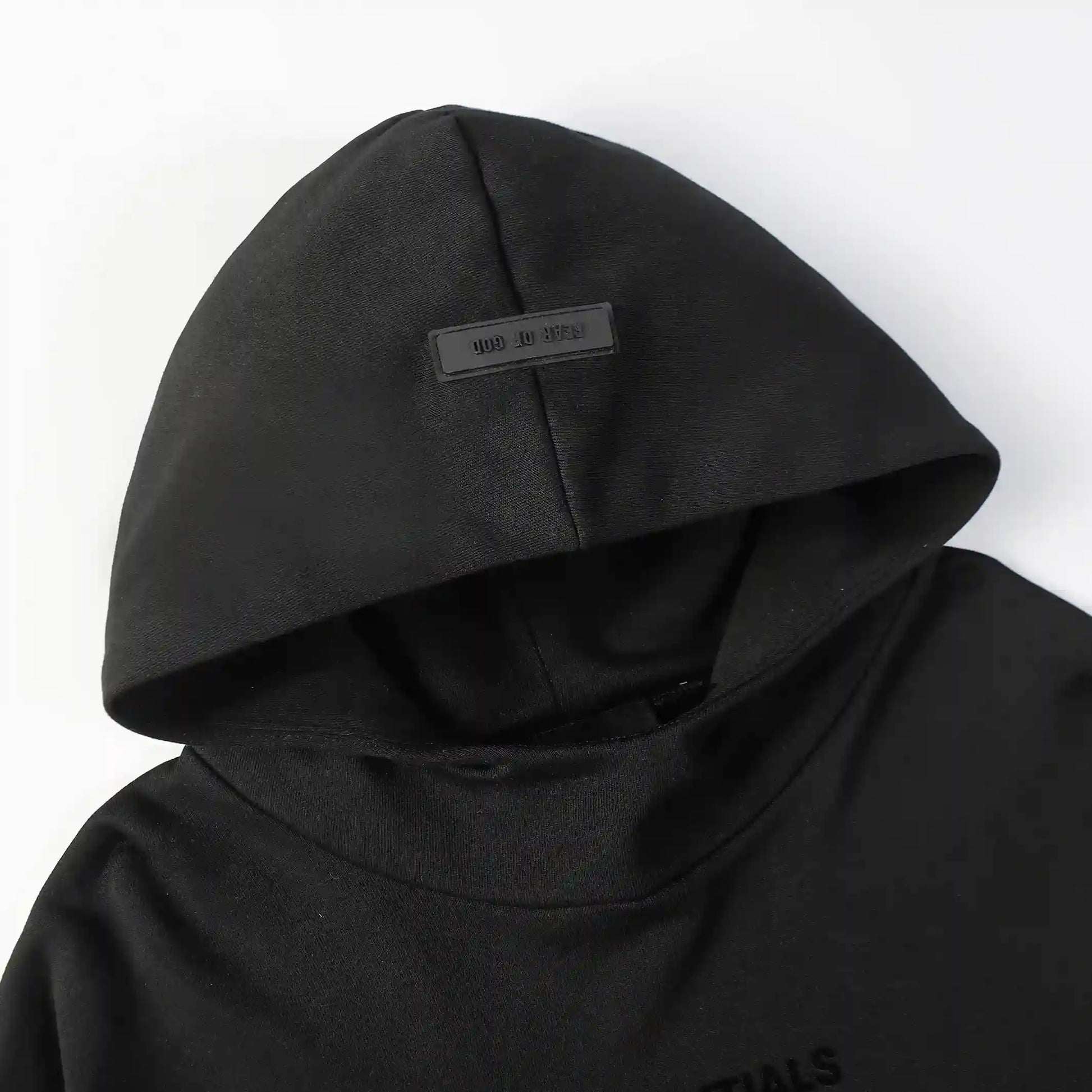 Black Essentials joggers soft-touch rubberized logo on leg close-up