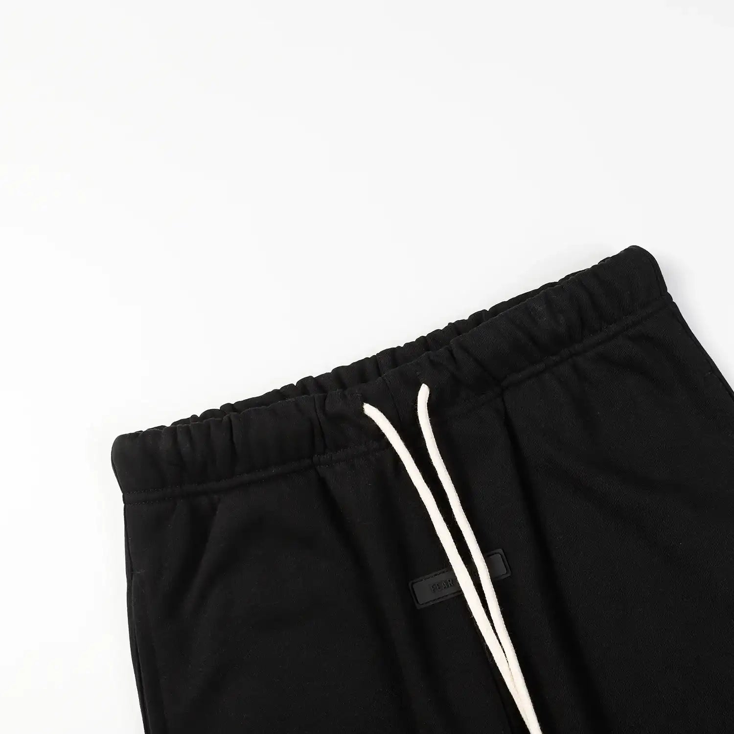 Essentials rubberized label detail on black hoodie tracksuit