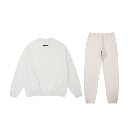 Essentials tracksuit cloud dance angled view relaxed fit crewneck set