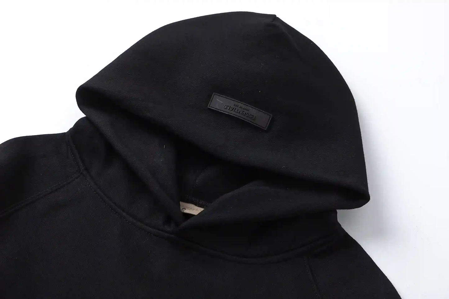 Back view of Essentials black timeless comfort fleece tracksuit set  by Fear Of God
