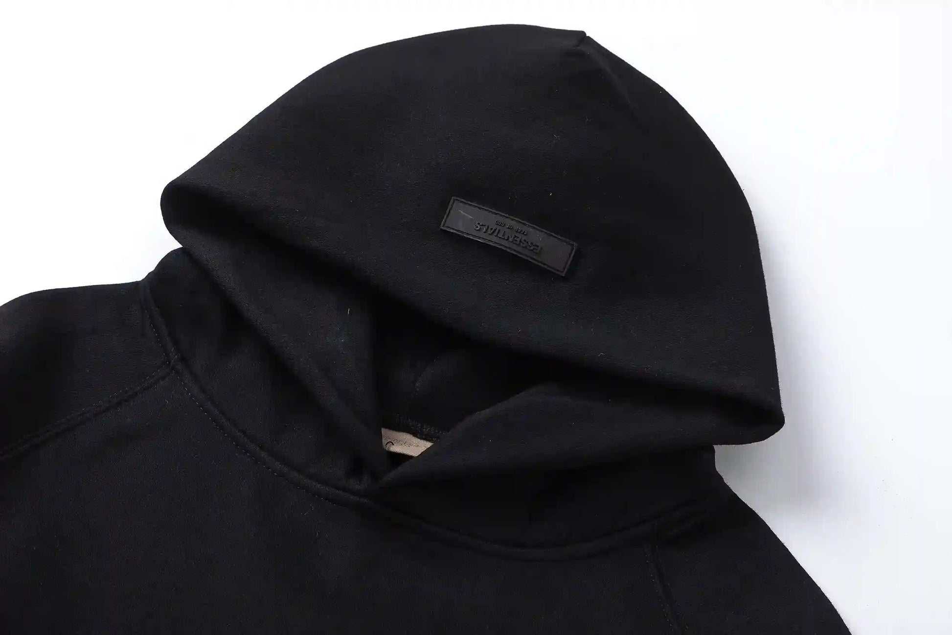 Back view of Essentials black timeless comfort fleece tracksuit set  by Fear Of God