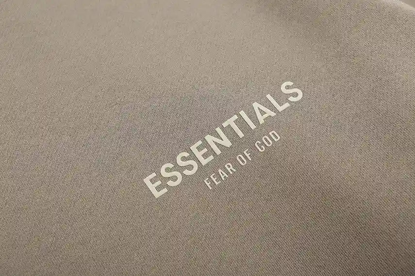 Essentials translucent rubberized sleeve label close-up sandrift sweatshirt
