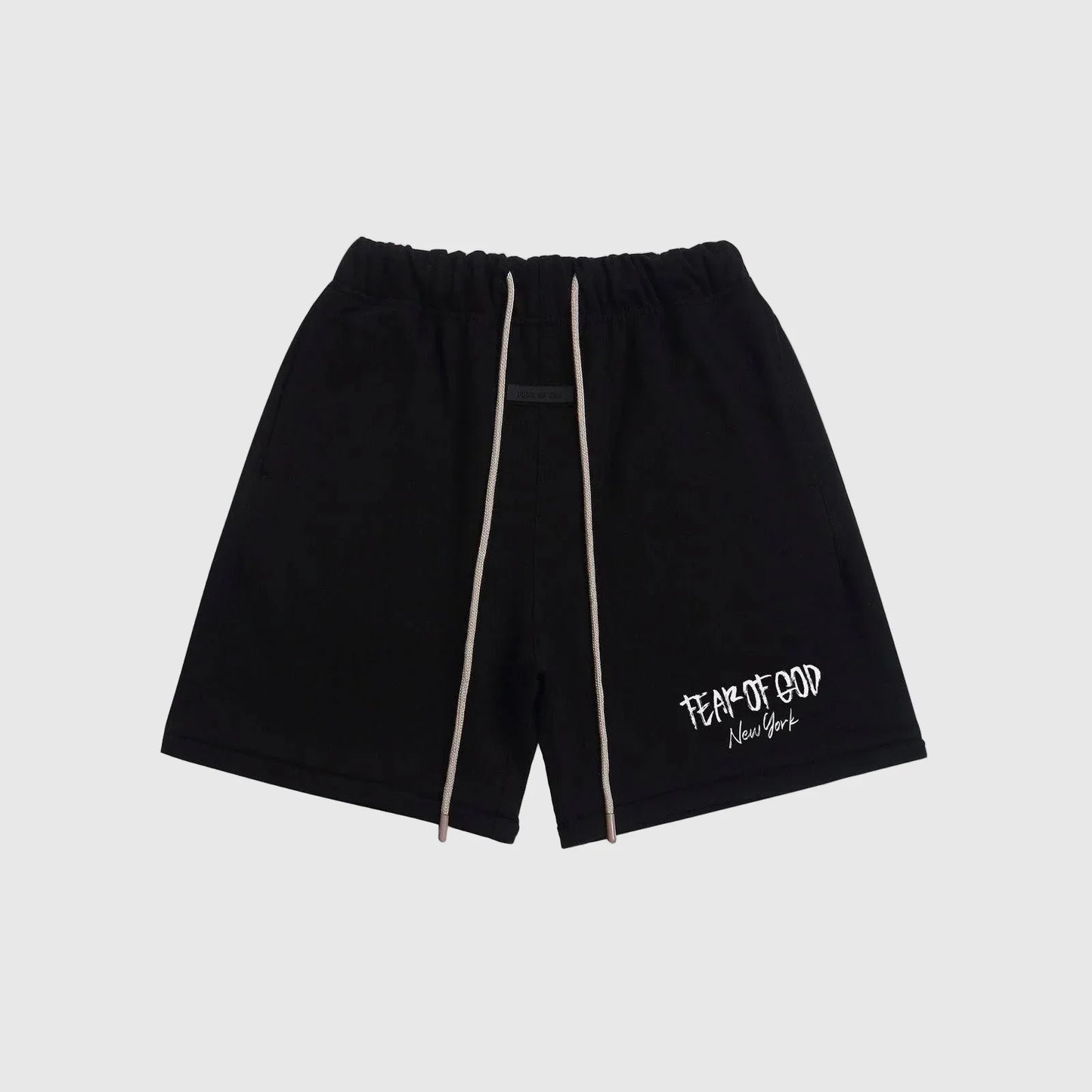 Fear of God Essentials black sweatshorts with drawstring waistband and logo detailing.